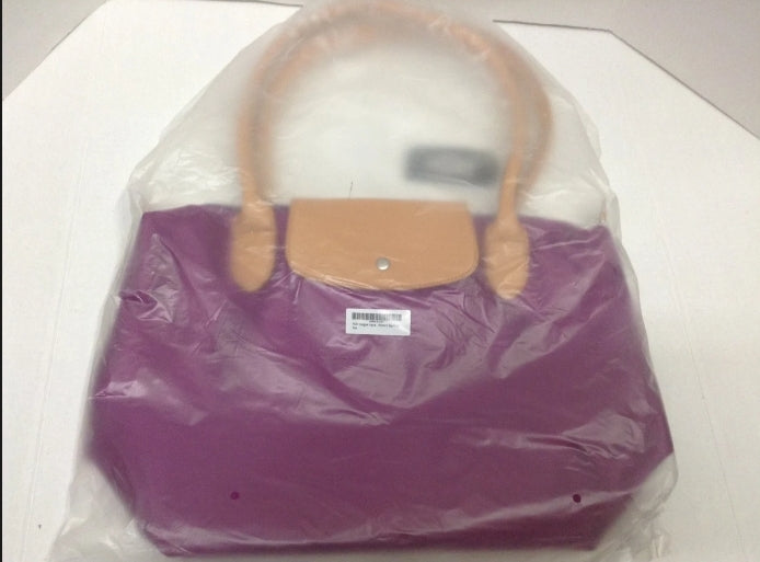 New with tags! Zipper closure with a snap flap, inside pockets, original plastic packaging! Vivid violet color